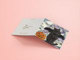 Halloween themed blank greeting card of a black cat wearing bat wings sat next to a pumpkin. Reproduction of an original Painting by Irish Wildlife Artist Jessica Ivy  Edit alt text