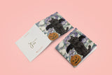 Halloween themed blank greeting card of a black cat wearing bat wings sat next to a pumpkin. Reproduction of an original Painting by Irish Wildlife Artist Jessica Ivy  Edit alt text